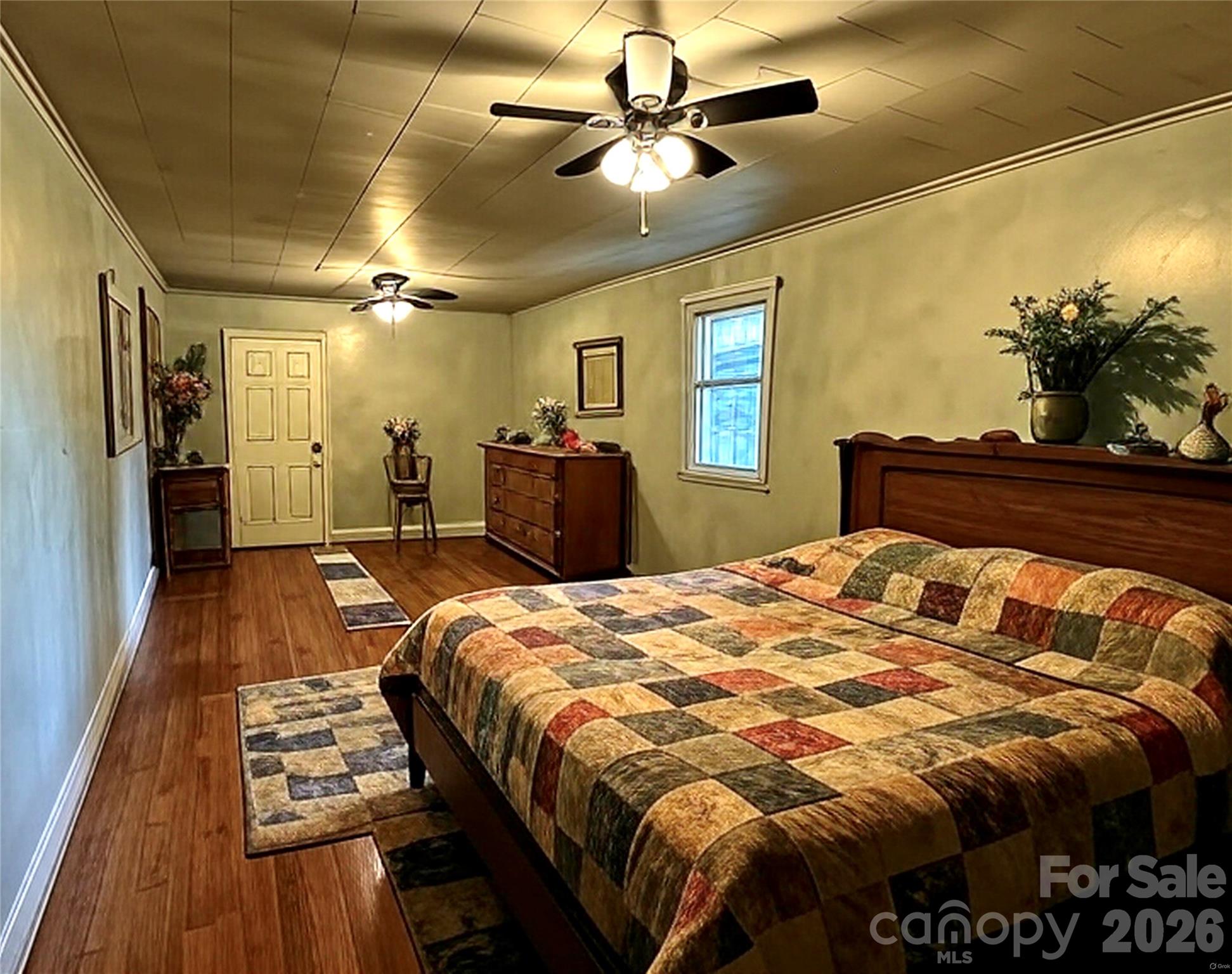 208 Murdock Road Bakersville, NC 28705 - Photo 17 of 46 a bed sitting in a bedroom and a chandelier