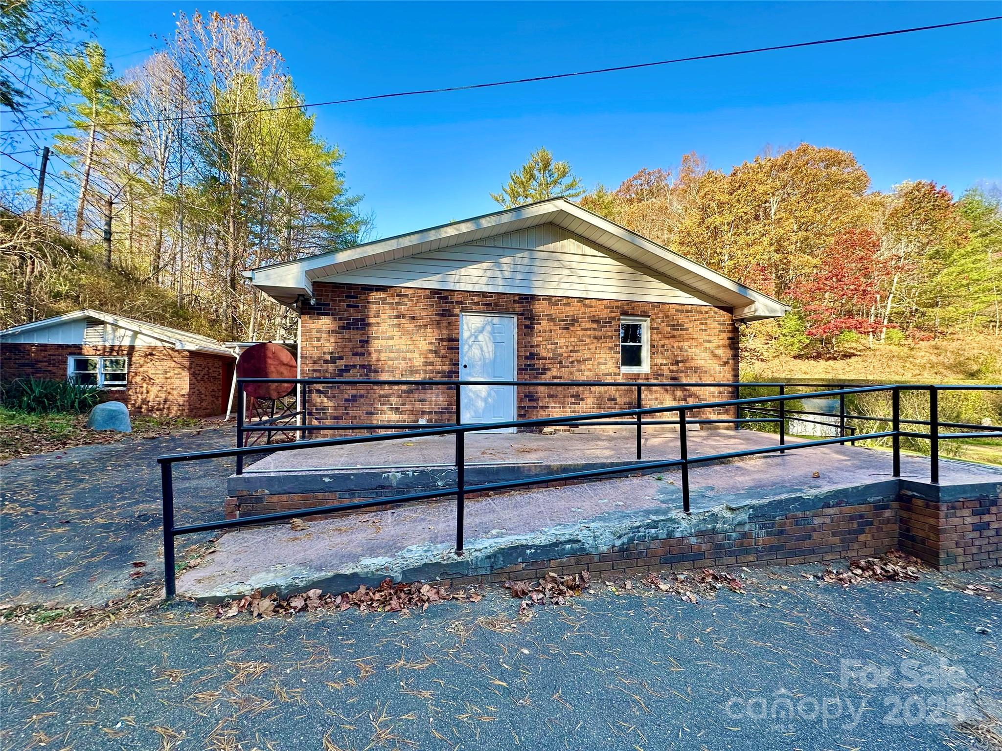 208 Murdock Road Bakersville, NC 28705 - Photo 22 of 32 a view of a small house next to a yard