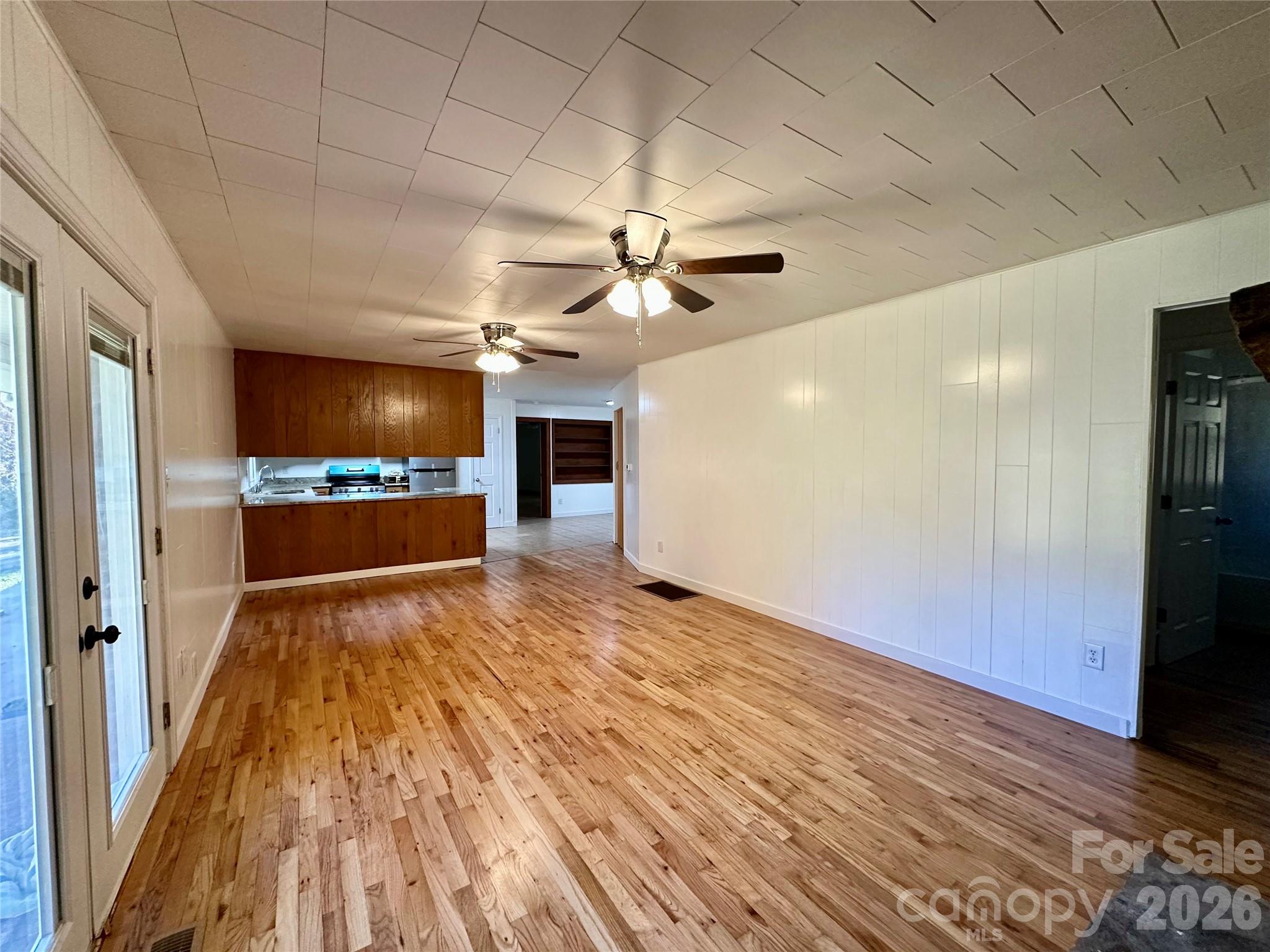 208 Murdock Road Bakersville, NC 28705 - Photo 22 of 46 a view of an empty room with a kitchen and a window