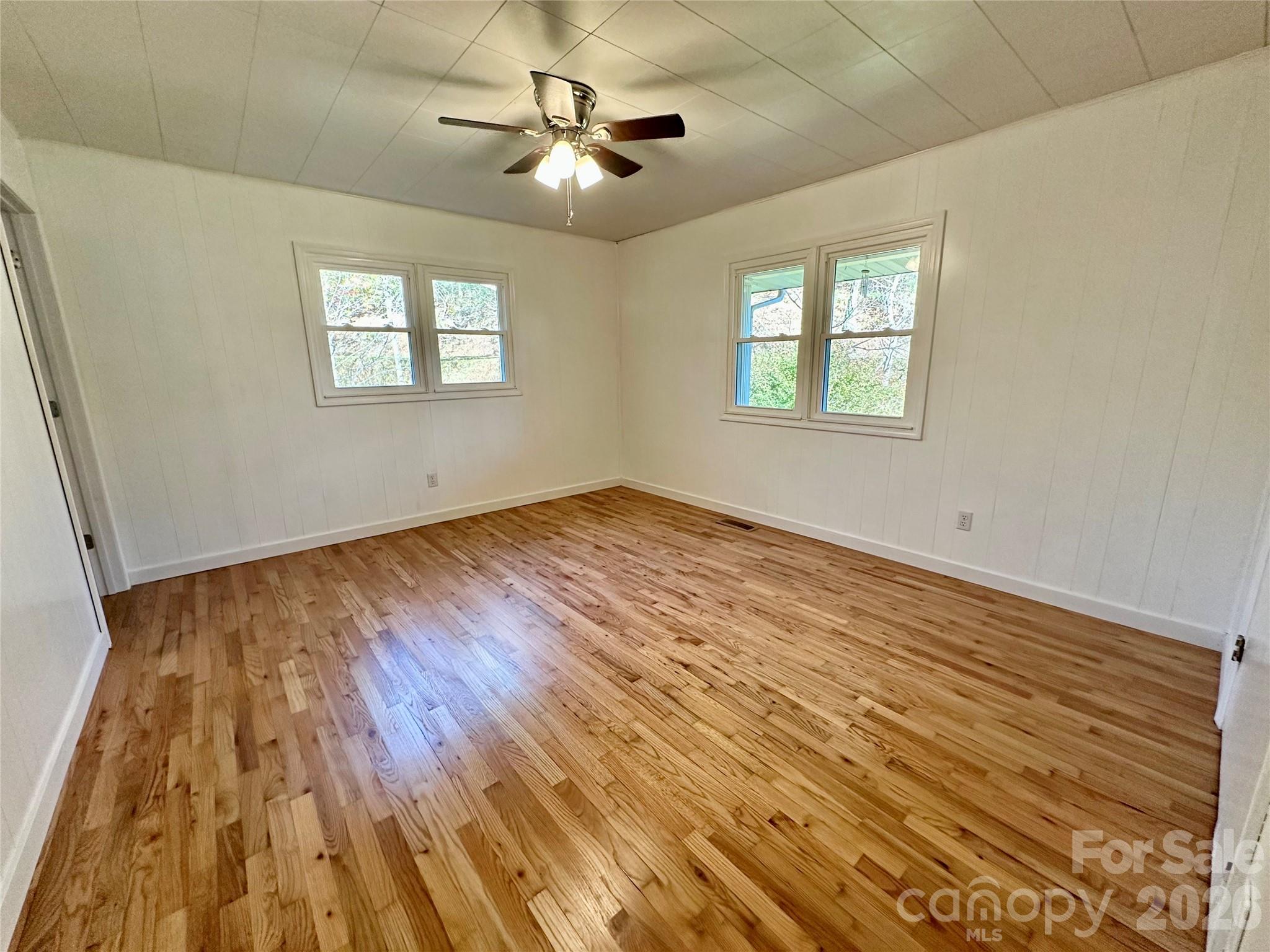 208 Murdock Road Bakersville, NC 28705 - Photo 24 of 46 a view of an empty room with a window and wooden floor