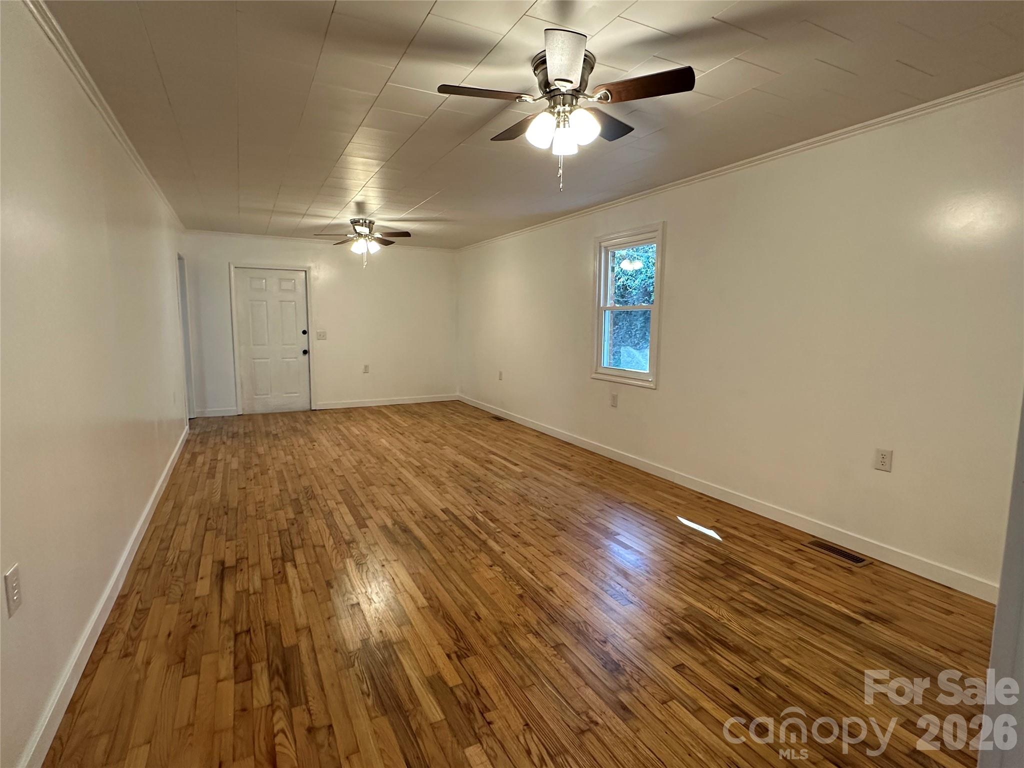 208 Murdock Road Bakersville, NC 28705 - Photo 25 of 46 wooden floor in an empty room with a window