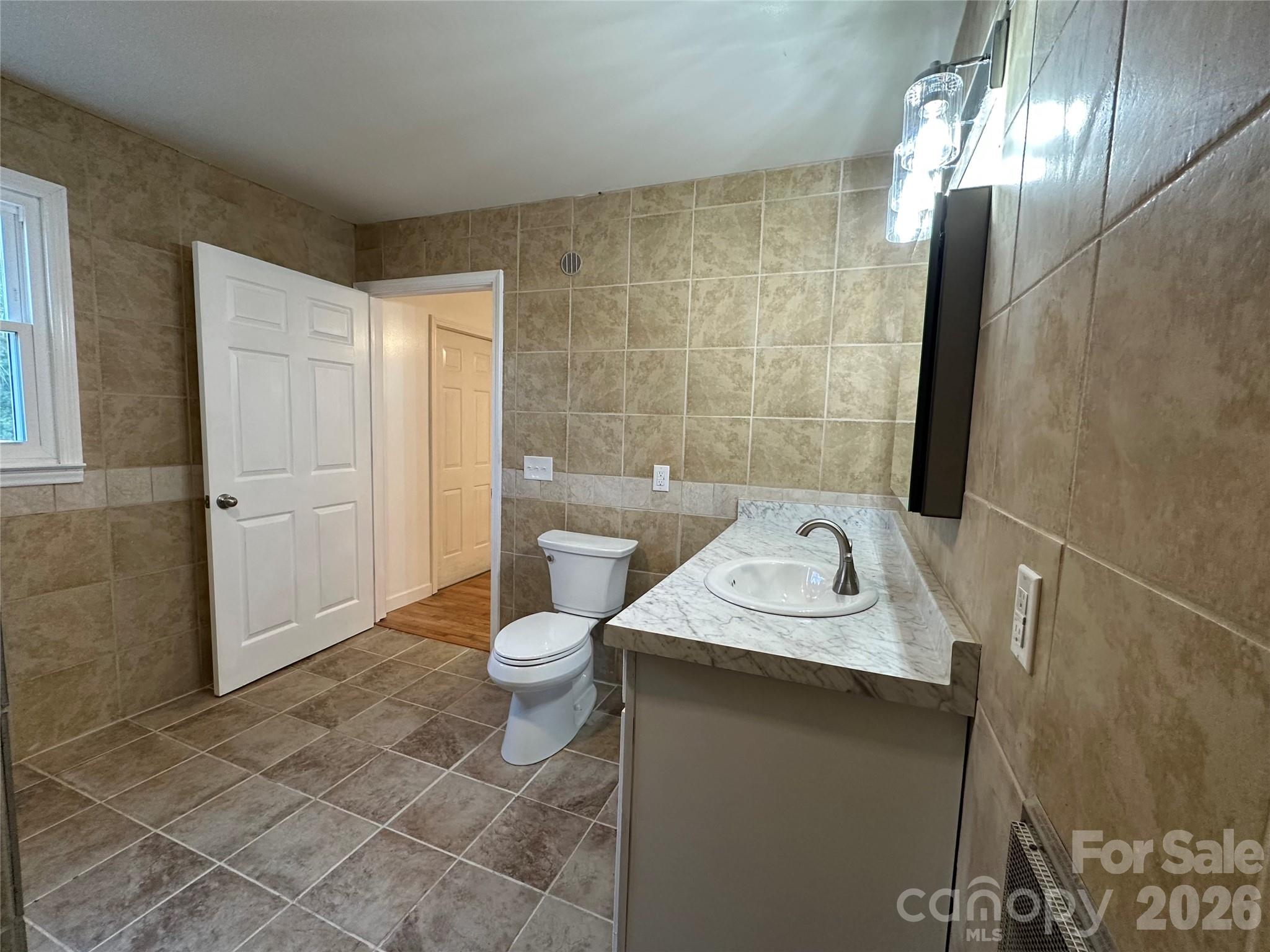 208 Murdock Road Bakersville, NC 28705 - Photo 28 of 46 a bathroom with a sink a toilet and shower