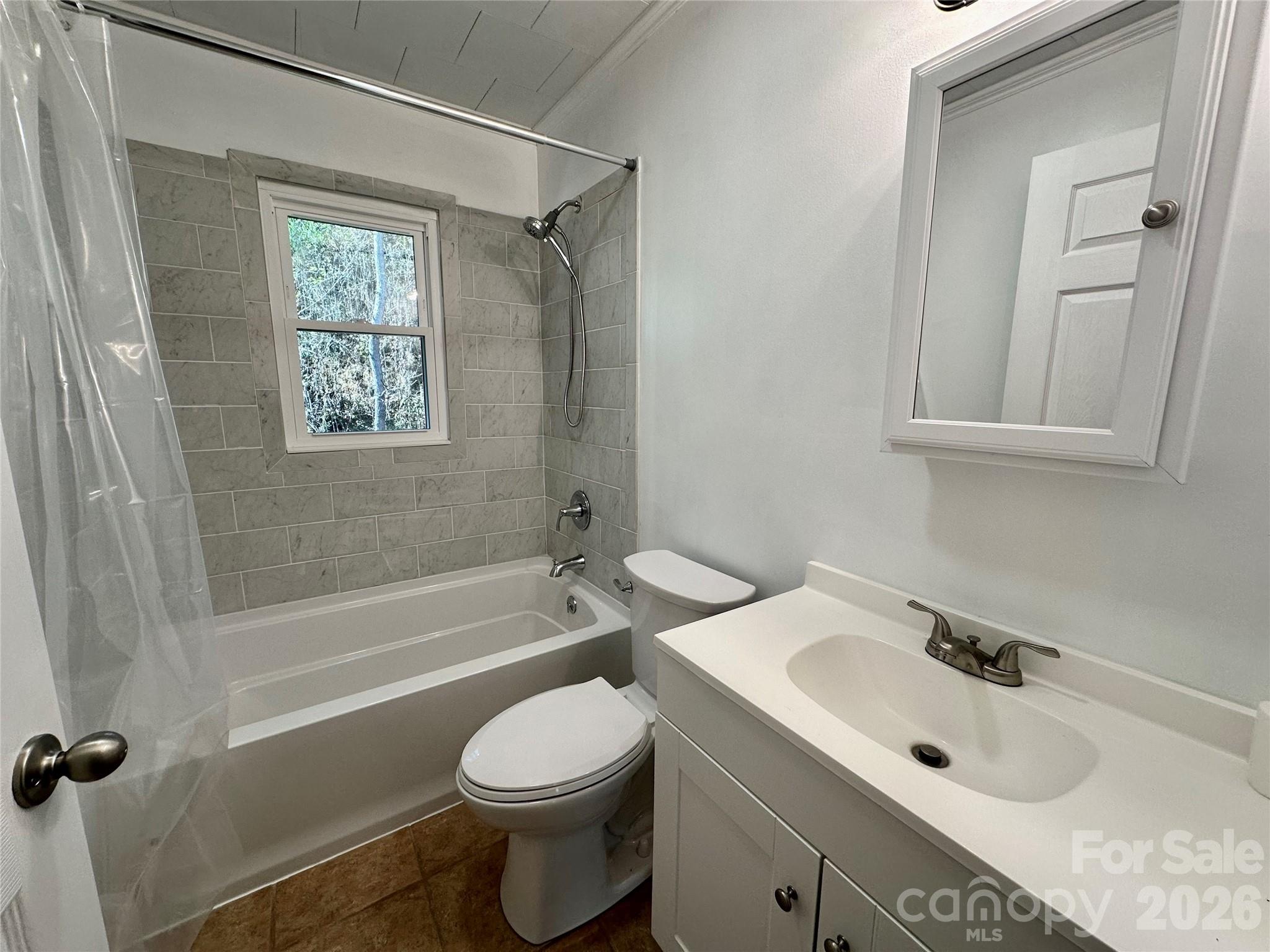 208 Murdock Road Bakersville, NC 28705 - Photo 29 of 46 a bathroom with a bathtub shower sink vanity and toilet