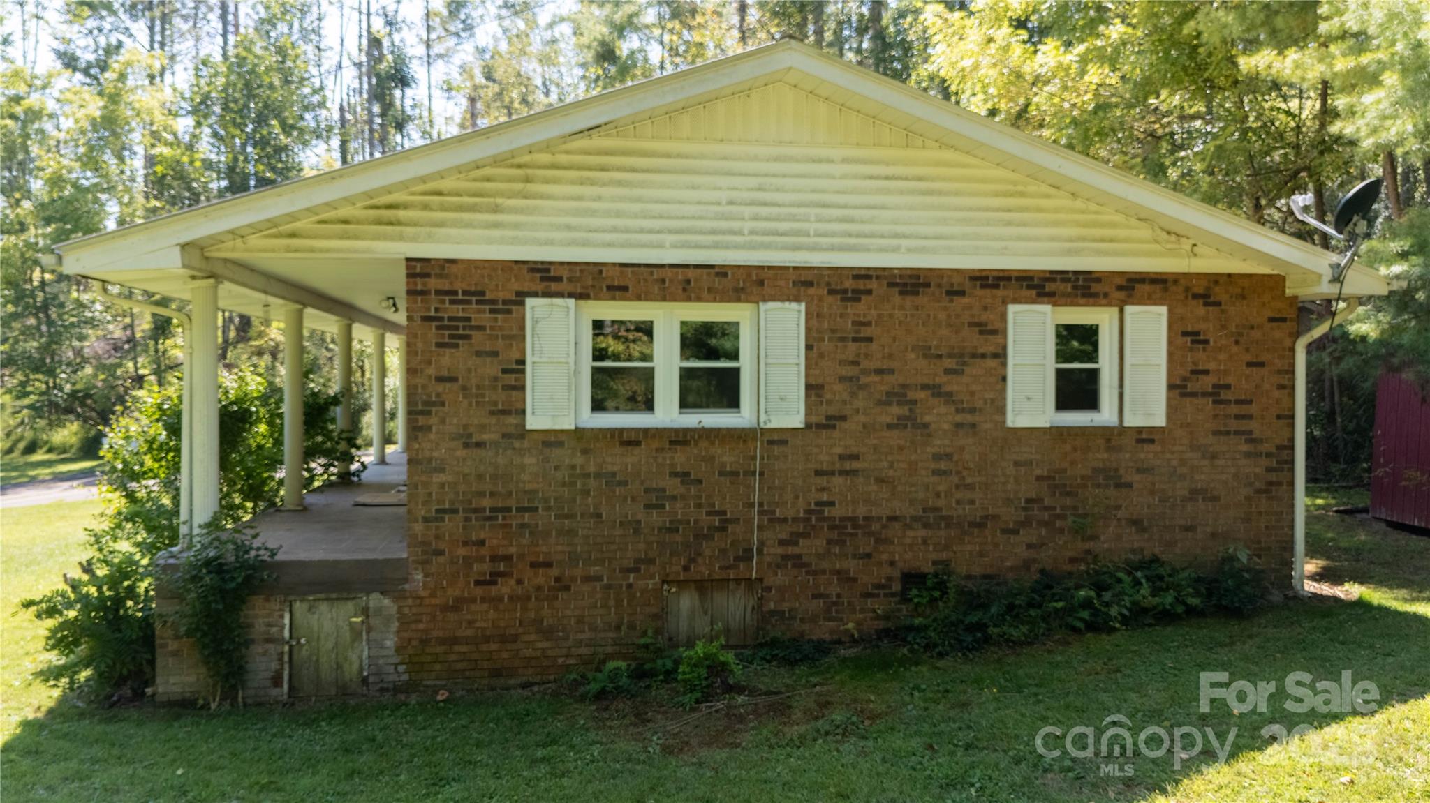 208 Murdock Road Bakersville, NC 28705 - Photo 30 of 32 a front view of a house with garden