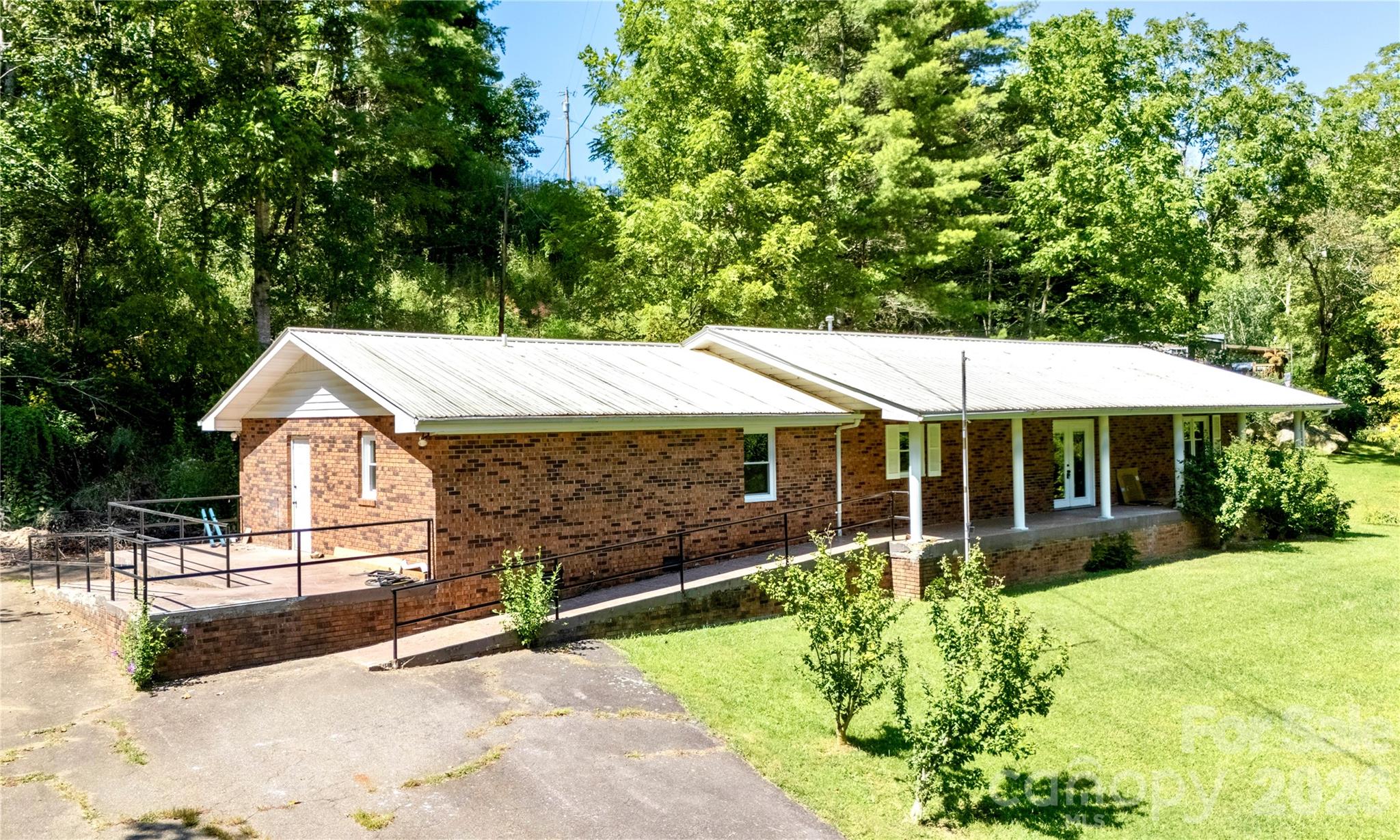 208 Murdock Road Bakersville, NC 28705 - Photo 4 of 46 a backyard of a house with yard and outdoor seating