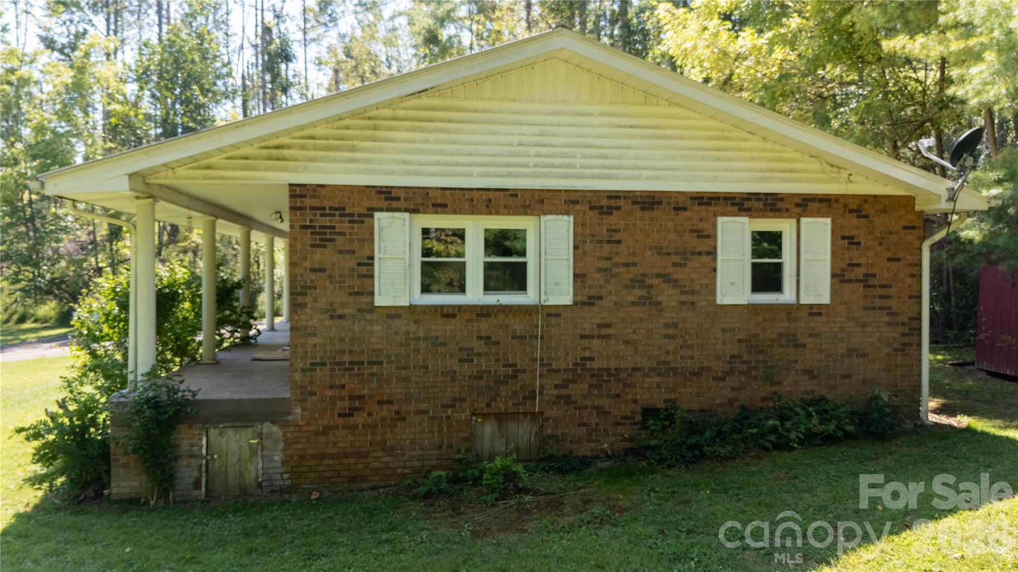 208 Murdock Road Bakersville, NC 28705 - Photo 41 of 46 a front view of a house with garden