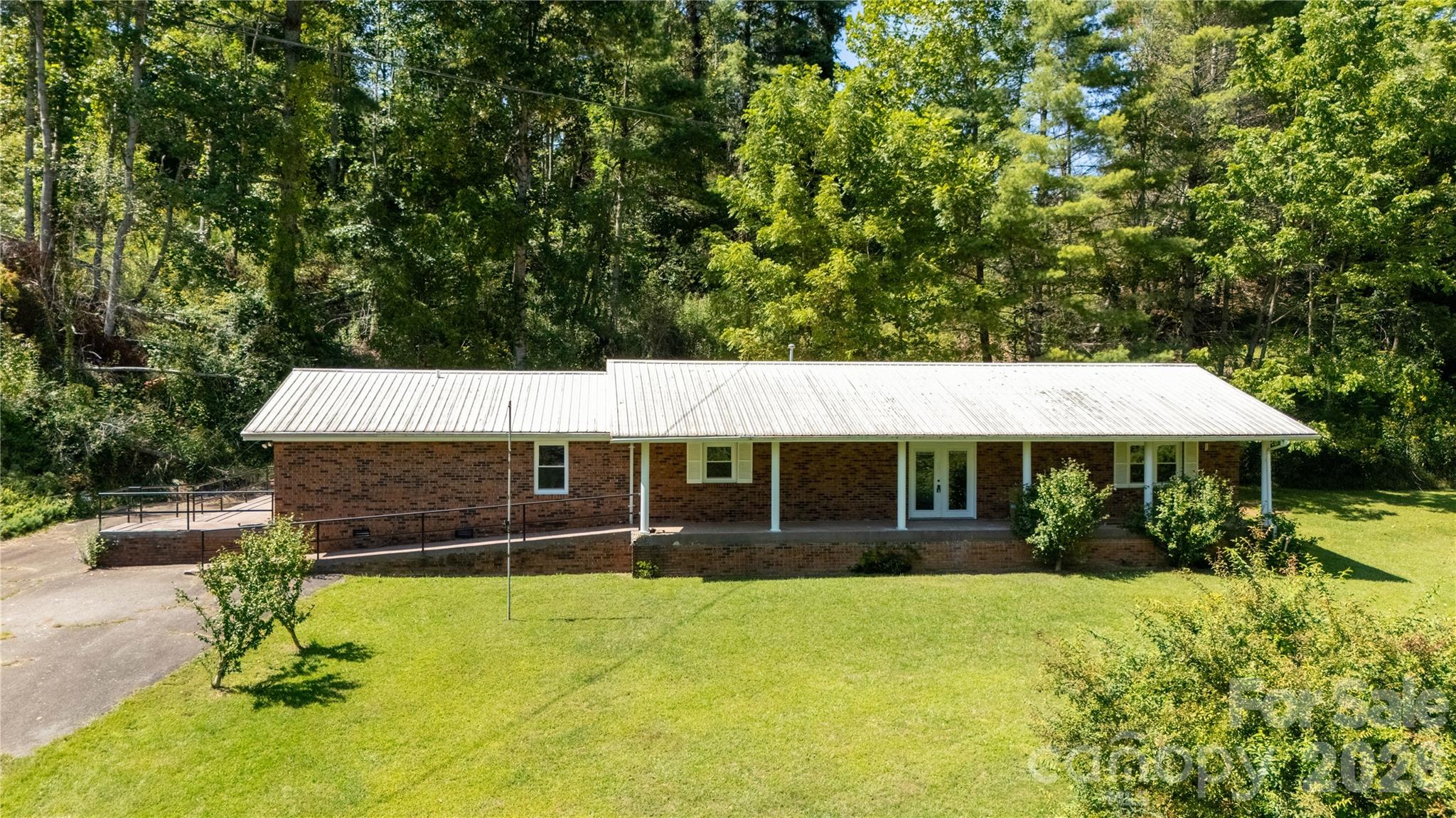 208 Murdock Road Bakersville, NC 28705 - Photo 42 of 46 a view of a house with a yard