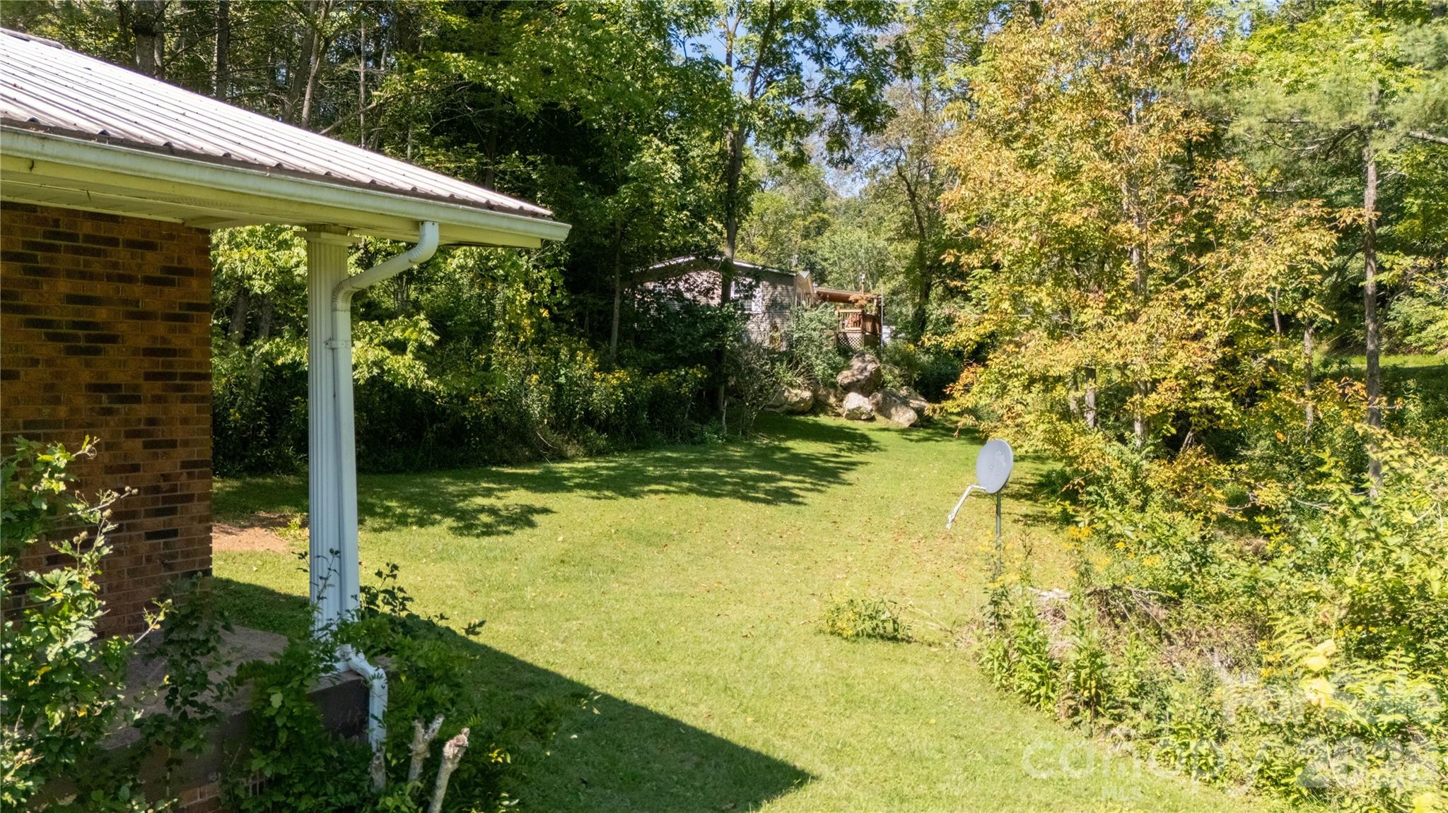 208 Murdock Road Bakersville, NC 28705 - Photo 43 of 46 a view of a pathway of a yard with plants