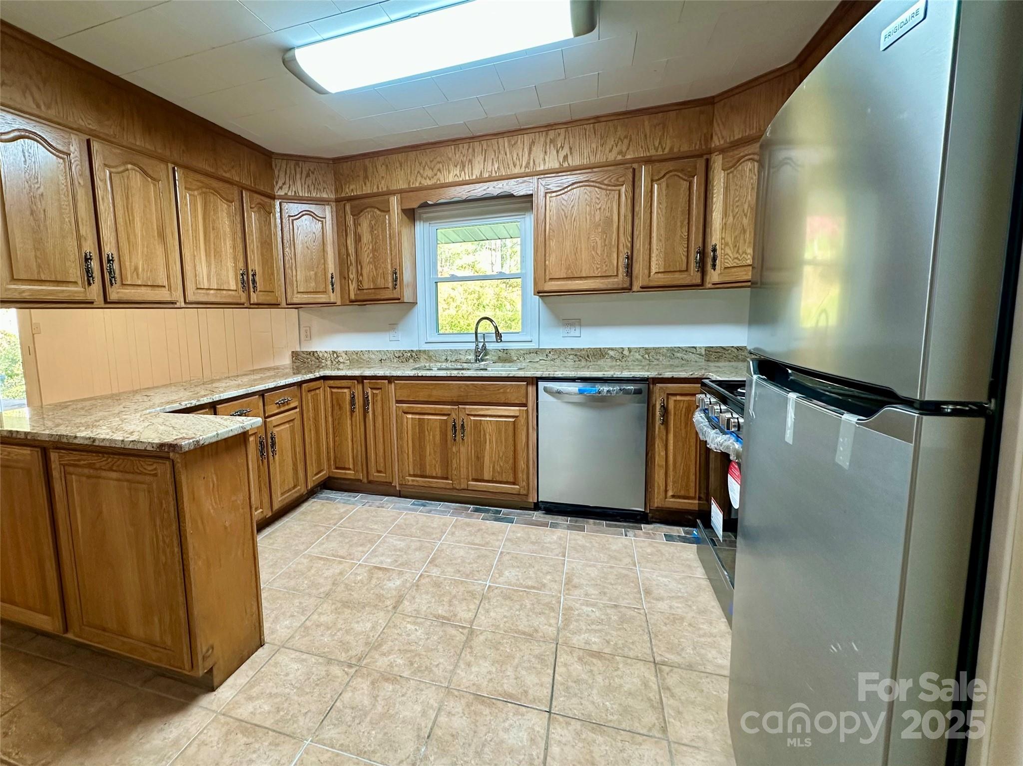 208 Murdock Road Bakersville, NC 28705 - Photo 6 of 32 a kitchen with stainless steel appliances granite countertop a sink stove and cabinets