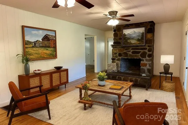 a living room with furniture a flat screen tv and a fireplace