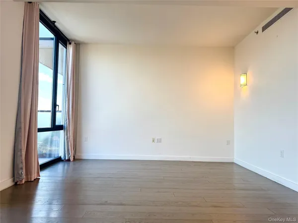 a view of an empty room and wooden floor