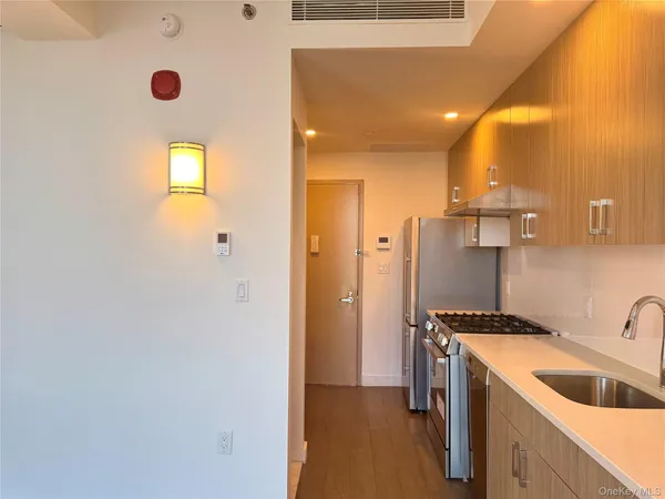 a kitchen with a refrigerator and a sink