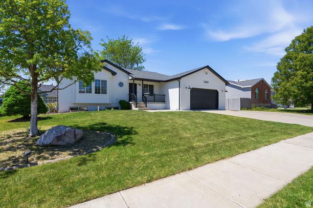 2460 Allison Way Syracuse, UT 84075 - Photo 3 of 24 Modern ranch-style home featuring a white exterior, dark trim, and a black garage door