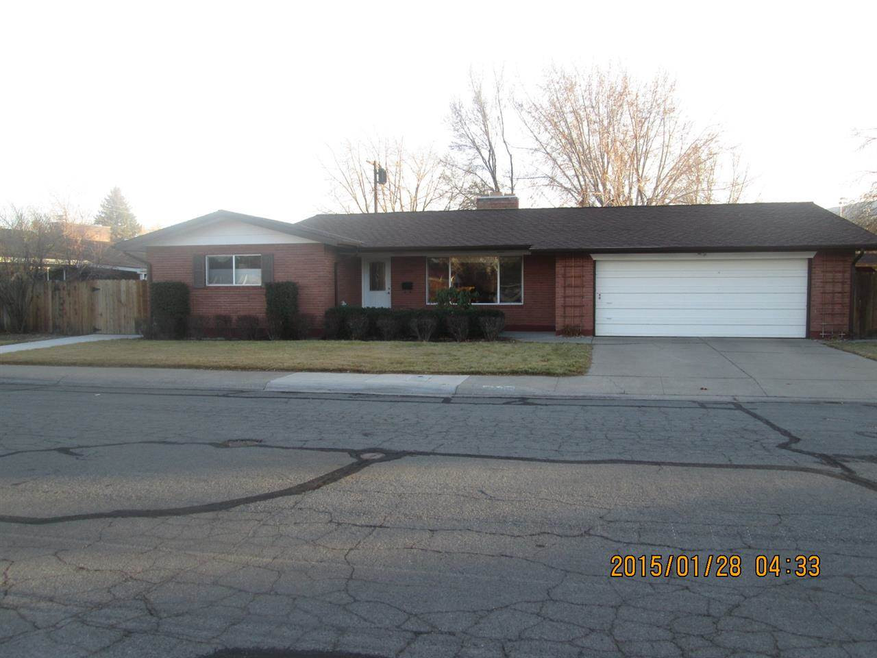 2050 Allen Street Reno, NV 89509 - Photo 1 of 1 a front view of a house with a yard and garage