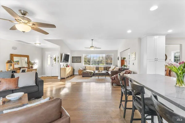 a living room with furniture and a chandelier