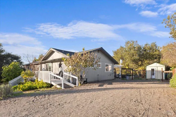 a view of a house with wooden fence