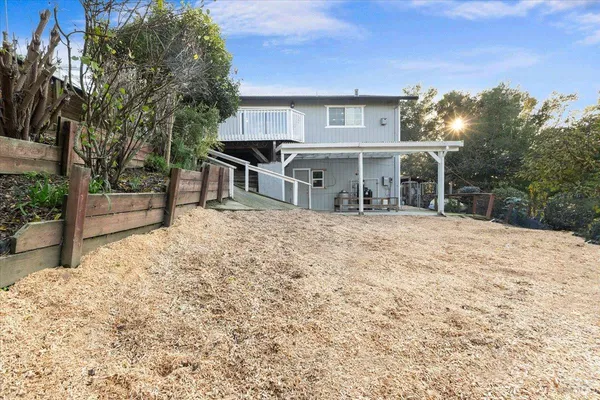 a view of a house with a yard and sitting area