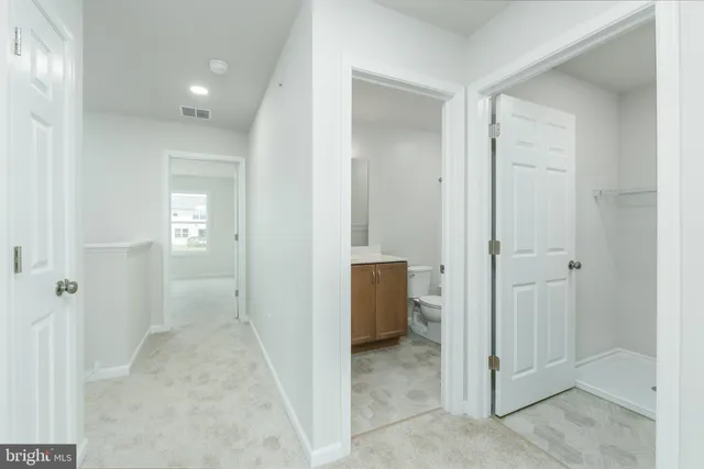wooden floor with a bathroom view