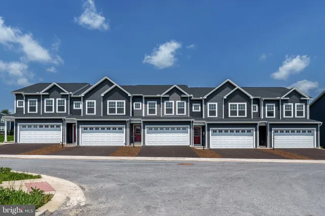a view of a brick house with large windows
