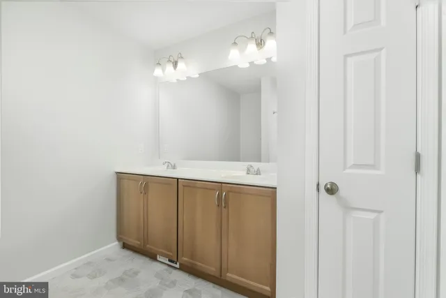 a bathroom with a double vanity sink and a mirror