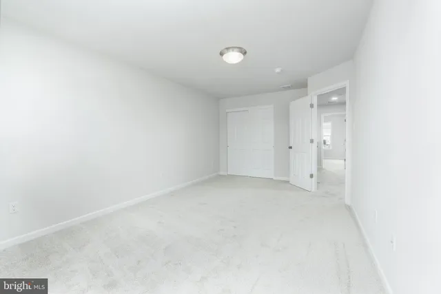 an empty room with windows and entrance