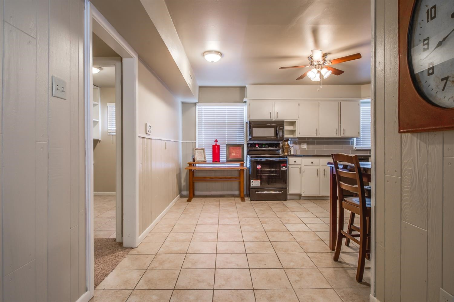 4319 40th Street Lubbock, TX 79413 - Photo 8 of 10 a kitchen with a refrigerator and cabinets