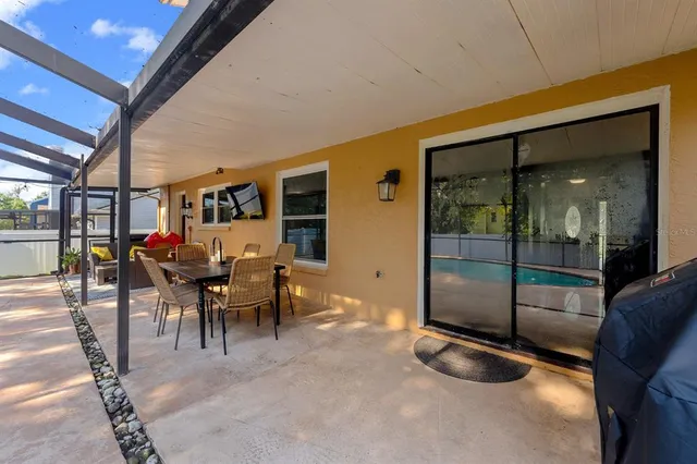 a dining room with furniture and a floor to ceiling window