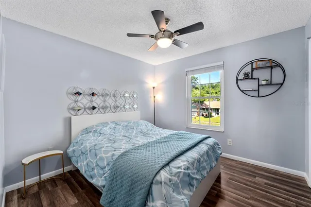 a bedroom with a bed a chandelier and a window