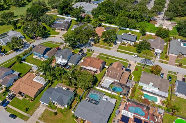 an aerial view of residential houses with outdoor space