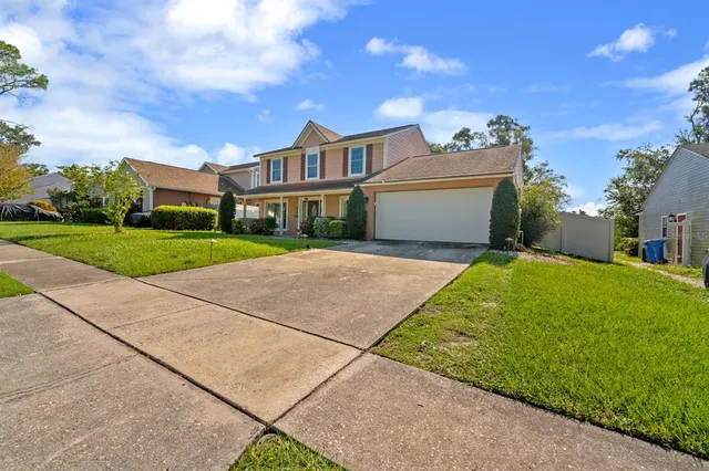 a view of house with yard and street view