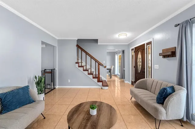 a living room with furniture and a chandelier