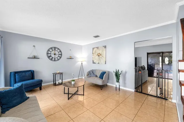 a living room with furniture and a potted plant