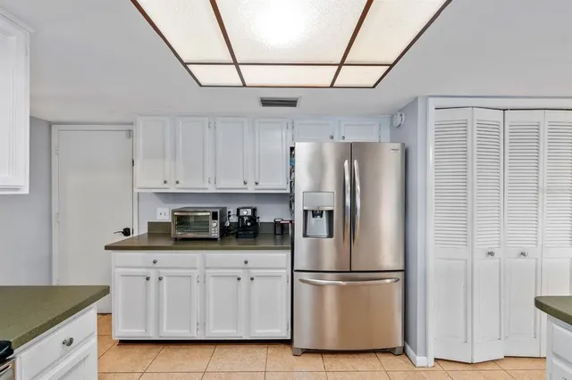 a kitchen with stainless steel appliances a refrigerator sink and cabinets