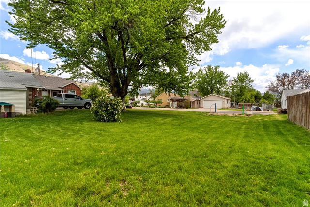 385 East Randall Way South, Unit 2 Centerville, UT 84014 - Photo 9 of 21 View of grassy yard with a residential view