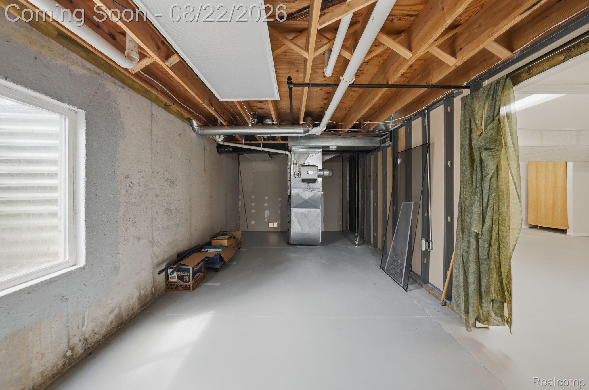 1301 Palms Road Columbus, MI 48063 - Photo 41 of 51 Daylight basement with exposed joist ceiling, concrete walls, and light-colored flooring