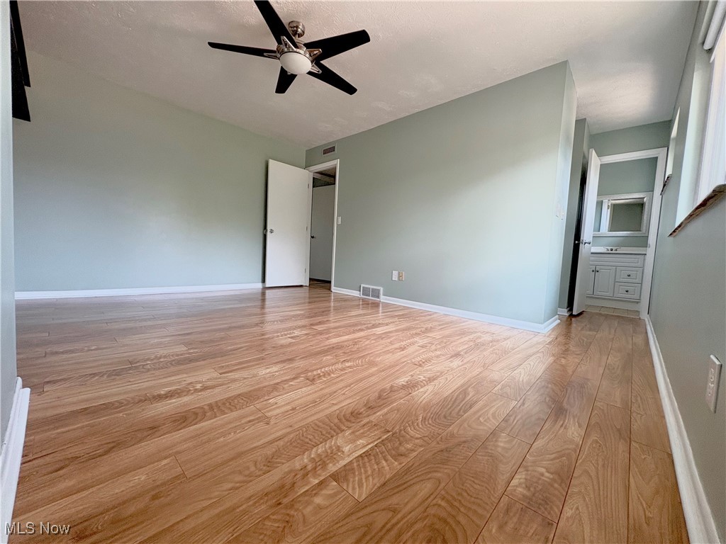 7050 Chillicothe Road, Unit C11 Mentor, OH 44060 - Photo 14 of 29 Empty room with light wood-style floors and a ceiling fan