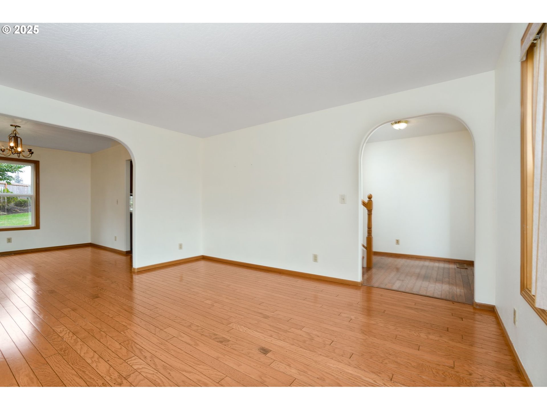 503 Southwest Mistmaiden Court Sublimity, OR 97385 - Photo 11 of 47 a view of an empty room with wooden floor and a window
