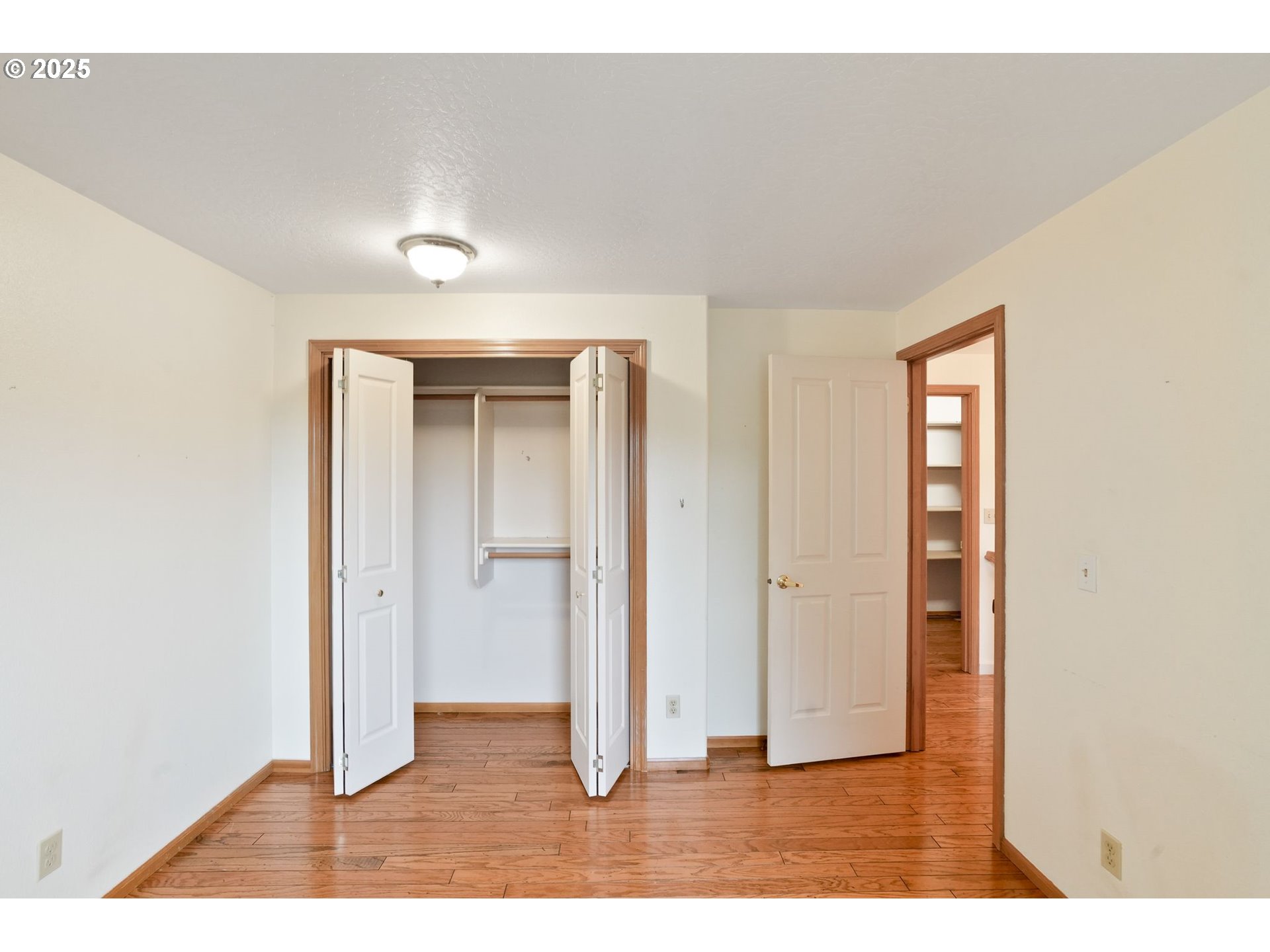 503 Southwest Mistmaiden Court Sublimity, OR 97385 - Photo 32 of 47 an empty room with wooden floor closet and windows
