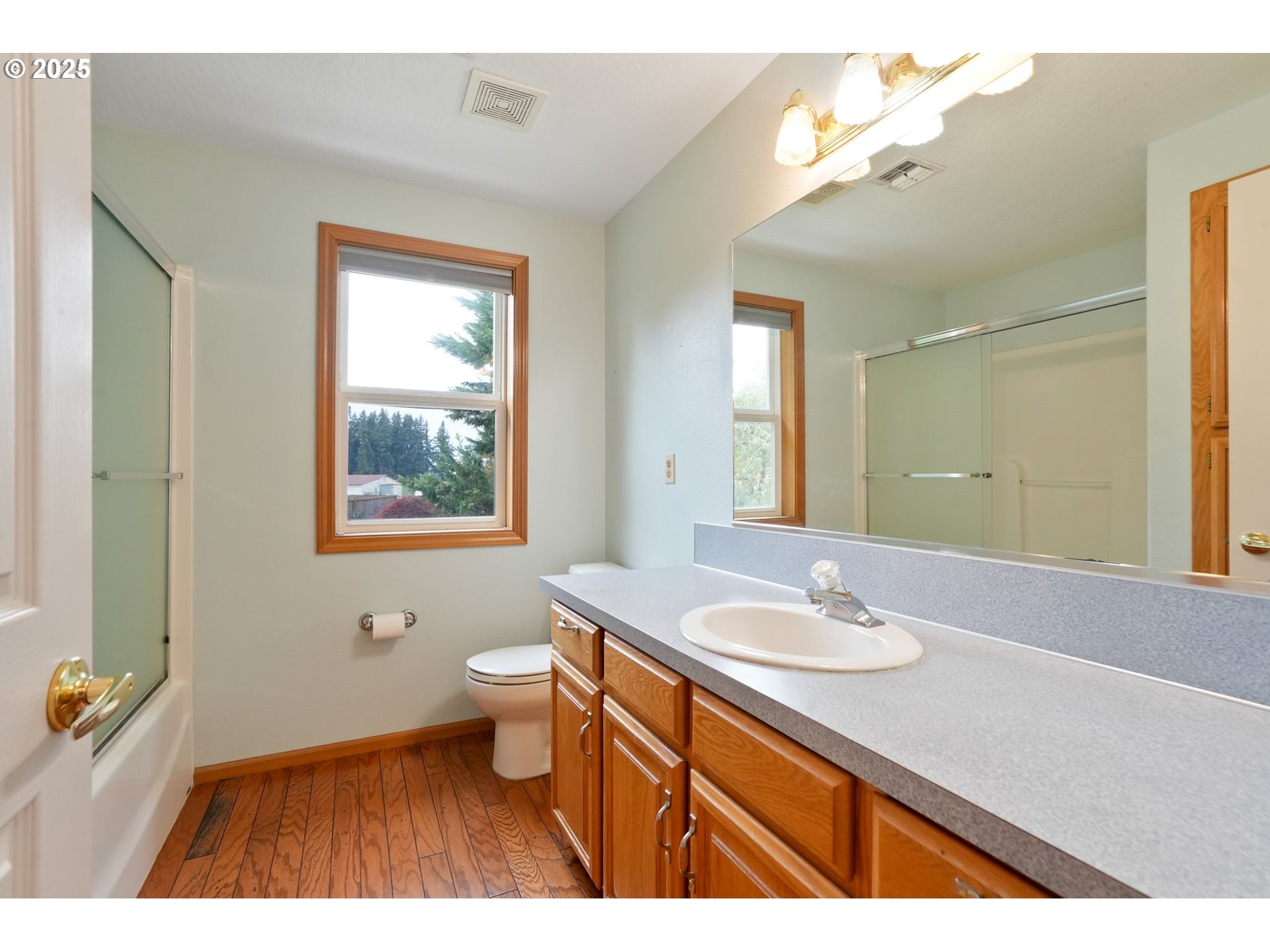 503 Southwest Mistmaiden Court Sublimity, OR 97385 - Photo 33 of 47 a bathroom with a sink a large mirror and a toilet