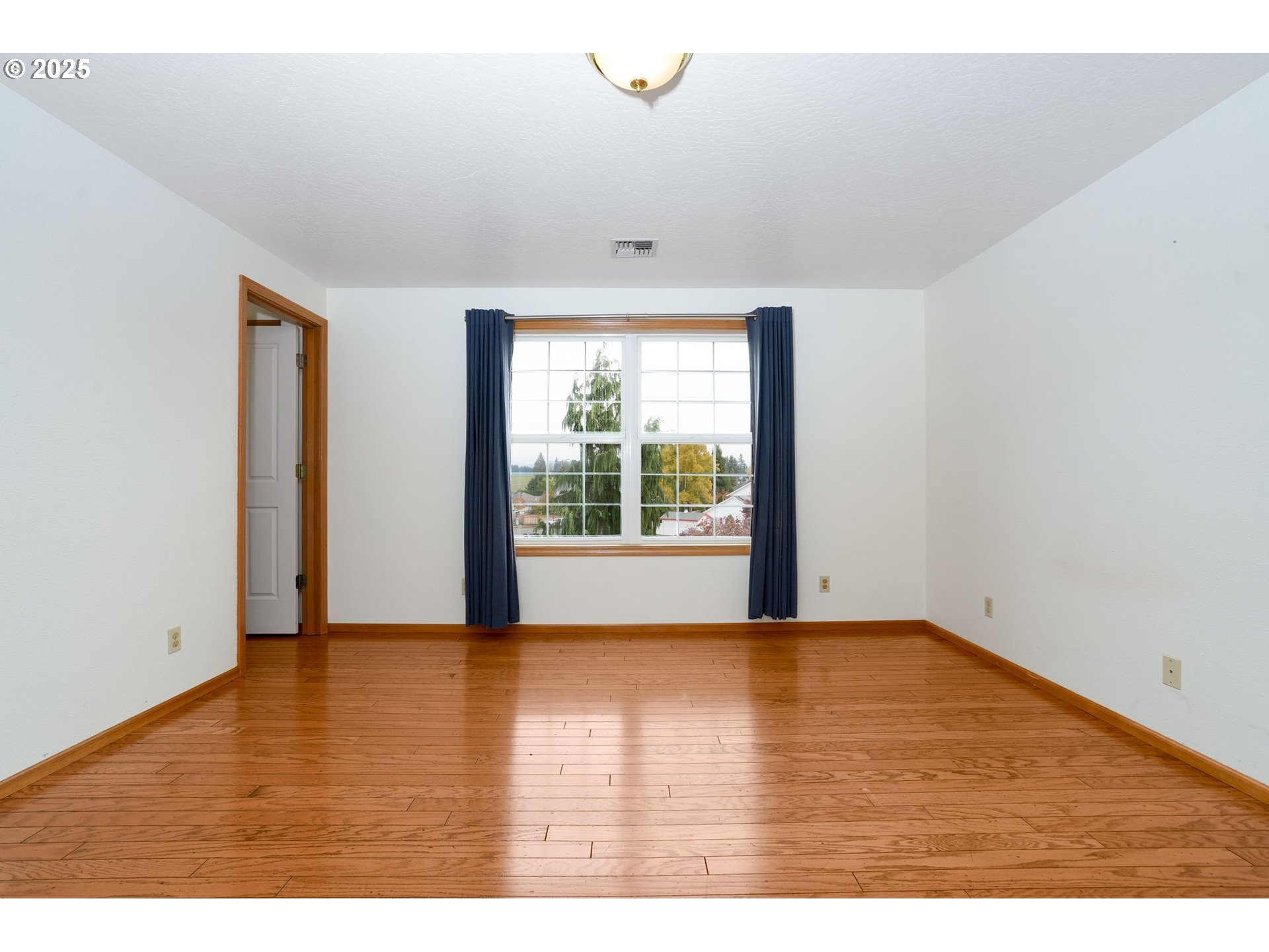 503 Southwest Mistmaiden Court Sublimity, OR 97385 - Photo 36 of 47 a view of an empty room with wooden floor and a window