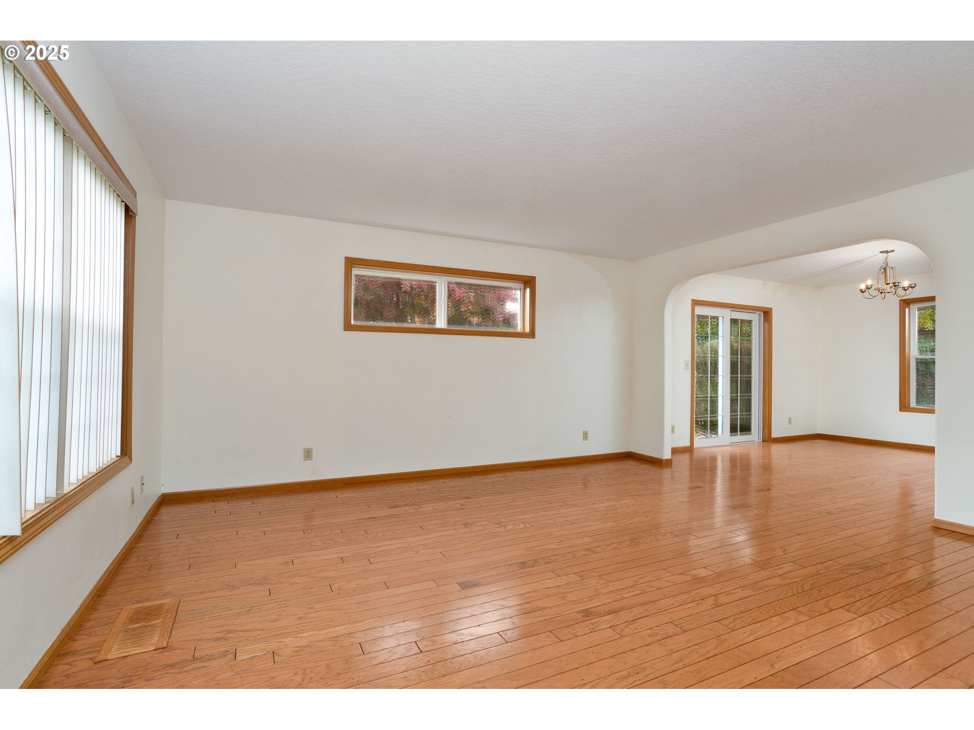 503 Southwest Mistmaiden Court Sublimity, OR 97385 - Photo 9 of 47 a view of an empty room with window and wooden floor