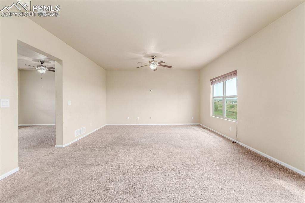7750 Dutch Loop Colorado Springs, CO 80925 - Photo 11 of 50 a view of a livingroom with a ceiling fan and window