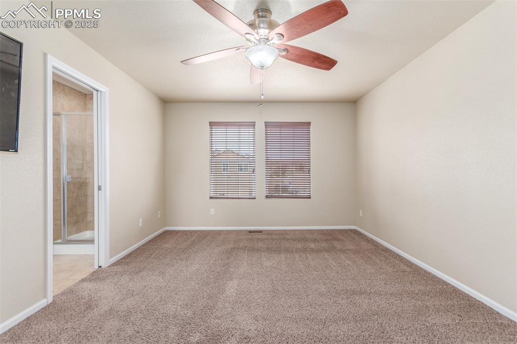 7750 Dutch Loop Colorado Springs, CO 80925 - Photo 12 of 50 an empty room with windows and fan