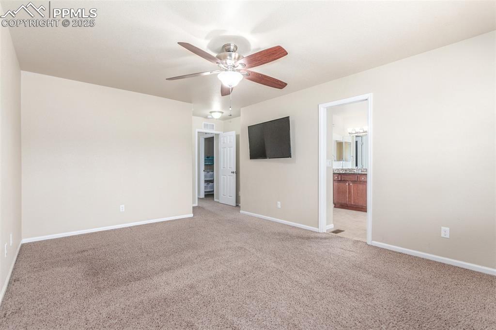 7750 Dutch Loop Colorado Springs, CO 80925 - Photo 13 of 50 a view of an empty room with a ceiling fan