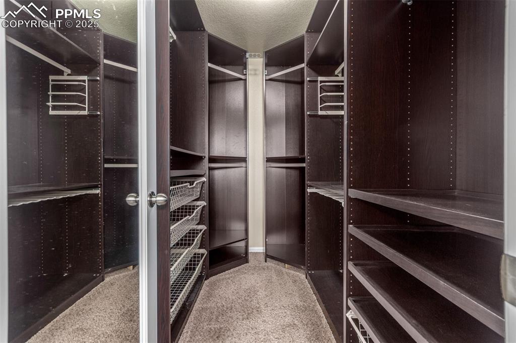 7750 Dutch Loop Colorado Springs, CO 80925 - Photo 18 of 50 a view of walk in closet with clothes and shoes