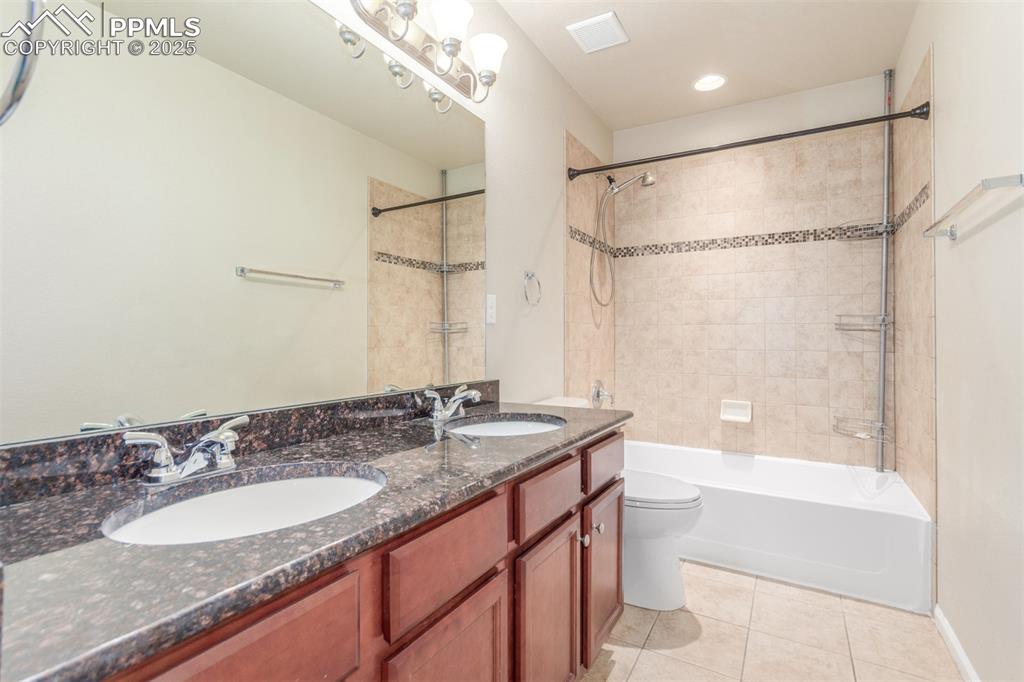 7750 Dutch Loop Colorado Springs, CO 80925 - Photo 21 of 50 a bathroom with a granite countertop sink mirror toilet and bathtub