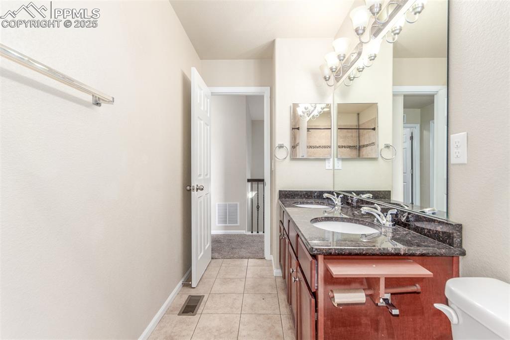 7750 Dutch Loop Colorado Springs, CO 80925 - Photo 23 of 50 a bathroom with a sink and a mirror