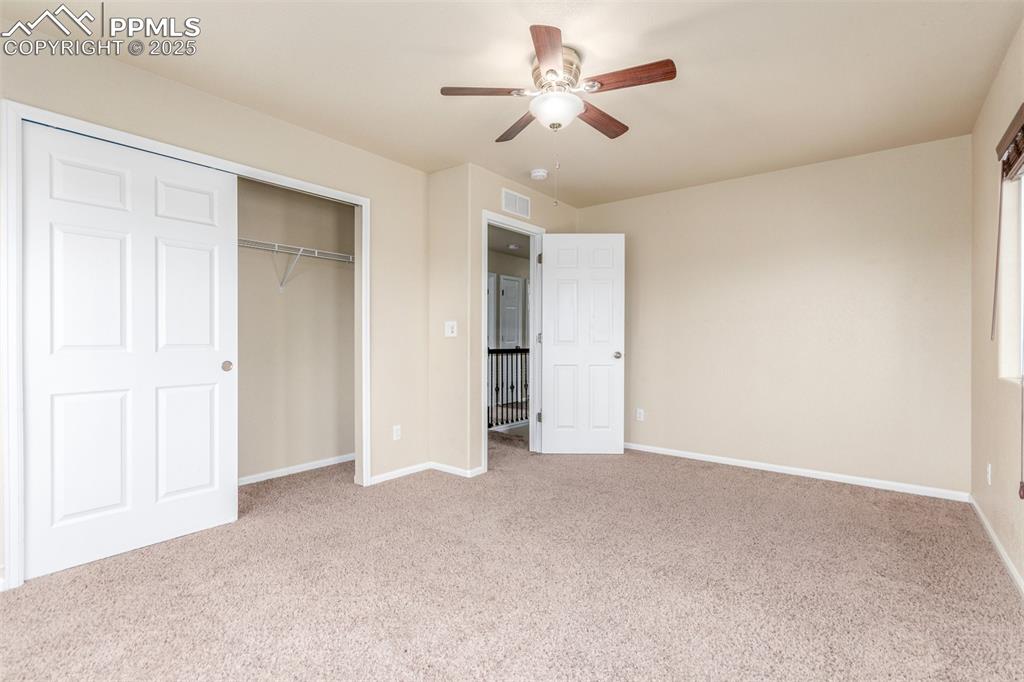 7750 Dutch Loop Colorado Springs, CO 80925 - Photo 24 of 50 a view of an empty room and a ceiling fan