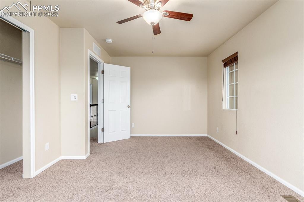 7750 Dutch Loop Colorado Springs, CO 80925 - Photo 25 of 50 a view of an empty room with a ceiling fan