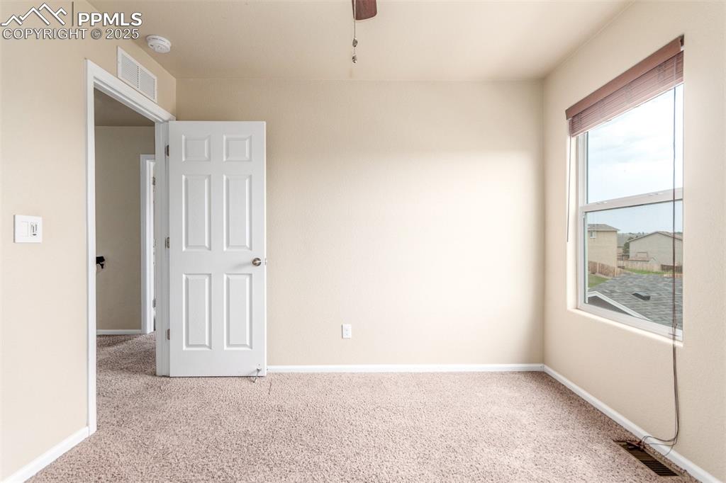 7750 Dutch Loop Colorado Springs, CO 80925 - Photo 28 of 50 an empty room with windows